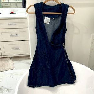 Denim romper skirt with a side zip. Style with different shirts underneath!